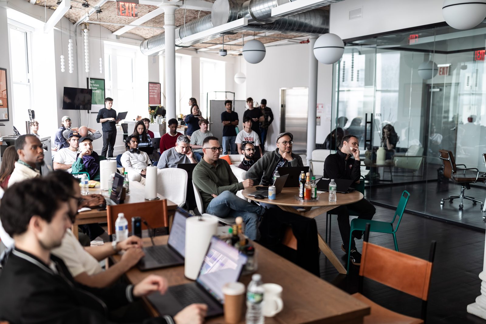 Valon teammates gathered with laptops in the New York office
